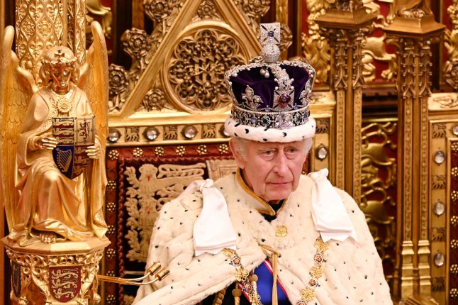 (FILES) Britain's King Charles III, wearing the Imperial State Crown and the Robe of State, sits on The Sovereign's Throne in the House of Lords chamber, during the State Opening of Parliament, at the Houses of Parliament, in London, on November 7, 2023. Britain's King Charles III has been diagnosed with a "form of cancer" according to a statement released by Buckingham Palace on February 5, 2024. (Photo by Leon Neal / POOL / AFP) (Photo by LEON NEAL/POOL/AFP via Getty Images)
