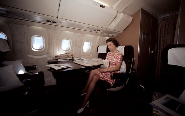 The Queen reading newspapers during her flight home from Bridgetown, Barbados, in the supersonic Concorde after her Silver Jubilee tour of Canada and the West Indies.