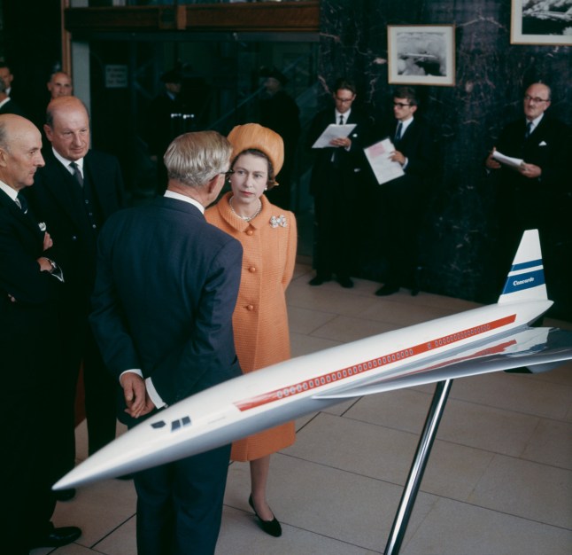 Queen Elizabeth II chatting with businessmen in front of a model of the Concorde airliner, at the British Aircraft Corporation works in Filton, Bristol, 8th September 1966. (Photo by George Freston/Fox Photos/Hulton Archive/Getty Images)