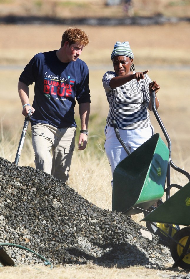 BUTHE BUTHE, LESOTHO - JULY 08: Prince Harry (L) helps rebuild a school on July 8, 2008 in Buthe Buthe, Lesotho. Prince Harry and 26 soldiers from the Household Cavalry are in Lesotho working to rebuild a school for children with chronic physical and mental disabilities. The Prince first visited Lesotho during his gap year in 2004 on the invitation of Prince Seeiso, the brother of the King of Lesotho. The pair subsequently set up the charity Sentebale meaning 'Forget Me Not' to help Lesotho's hundreds of thousands of orphans and vulnerable children. Prince Harry will spend three weeks working on the project. (Photo by Chris Jackson/Getty Images)