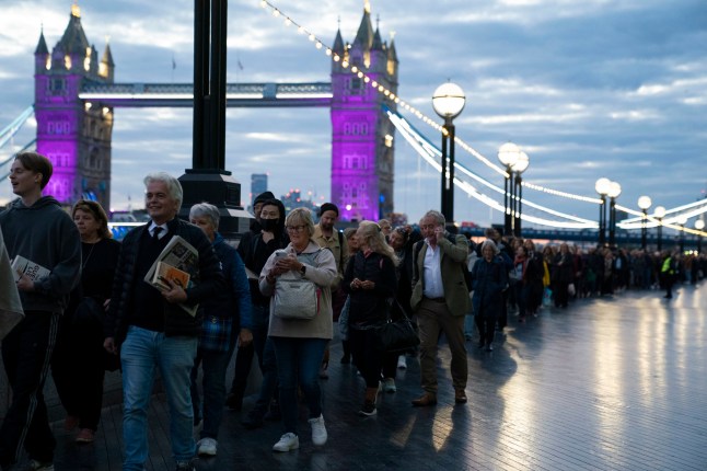 Members of the public in the queue at 06:09 on The Queen's Walk by Tower Bridge in London, as they wait to view Queen Elizabeth II lying in state ahead of her funeral on Monday. Picture date: Friday September 16, 2022. PA Photo. See PA story DEATH Queen. Photo credit should read: Kirsty O'Connor/PA Wire