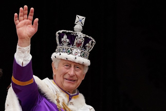(FILES) Britain's King Charles III wearing the Imperial state Crown, waves from the Buckingham Palace balcony after viewing the Royal Air Force fly-past in central London on May 6, 2023, after his coronation. Britain's King Charles III has been diagnosed with a "form of cancer" according to a statement released by Buckingham Palace on February 5, 2024. (Photo by Stefan Rousseau / POOL / AFP) (Photo by STEFAN ROUSSEAU/POOL/AFP via Getty Images)