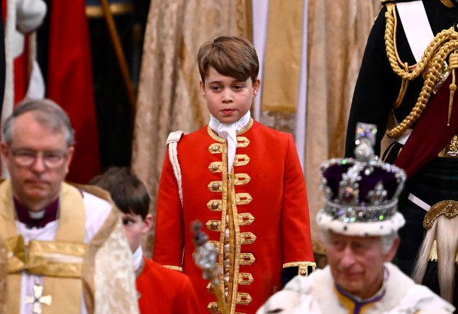 TOPSHOT - Page of Honour Prince George of Wales and Britain's King Charles III wearing the Imperial state Crown leave Westminster Abbey after the Coronation Ceremonies in central London on May 6, 2023. The set-piece coronation is the first in Britain in 70 years, and only the second in history to be televised. Charles will be the 40th reigning monarch to be crowned at the central London church since King William I in 1066. Outside the UK, he is also king of 14 other Commonwealth countries, including Australia, Canada and New Zealand. (Photo by Gareth Cattermole / POOL / AFP) (Photo by GARETH CATTERMOLE/POOL/AFP via Getty Images)