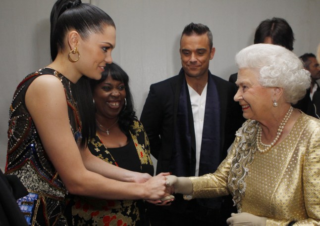Queen Elizabeth II greets British singer-songwriter Jessie J (L) and British singer Robbie Williams (C) backstage during the Diamond Jubilee Concert outside Buckingham Palace in London, on June 4, 20112. A chain of more than 4,200 beacons began to flare across the globe Monday to mark Queen Elizabeth II's diamond jubilee, with the last to be lit by the monarch at a star-studded concert at Buckingham Palace. AFP PHOTO / Dave Thompson /POOL (Photo credit should read Dave Thompson/AFP/GettyImages)