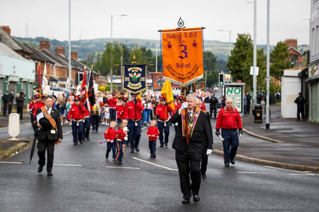 Bandsmen and Orange Order members of No 3 District Loyal Orange Lodge parade pass the nationalist area around Ardoyne shops in Belfast, as part of the annual Twelfth of July celebrations, marking the victory of King William III's victory over James II at the Battle of the Boyne in 1690. Picture date: Monday July 12, 2021. PA Photo. This year's Twelfth of July parades will be smaller than usual and locally based due to Covid-19 restrictions. The normal 18 main events have been replaced by more than 100 local parades. The Order said organising smaller parades was the best way to ensure the demonstrations went ahead. See PA story ULSTER Twelfth. Photo credit should read: Liam McBurney/PA Wire