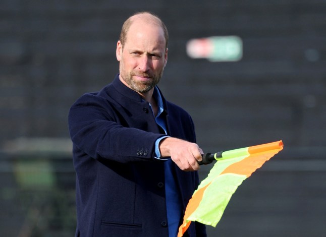 Britain's William, Prince of Wales waves the linesman's flag during a mini football game on an official visit to a FA Referee Training Course At Sporting Khalsa FC at Aspray Arena in Willenhall, England, March 11, 2025. Chris Jackson/Pool via REUTERS